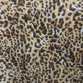 Leopard print pattern on a beige background Polyester Spandex Fabric | Spandex Palace
