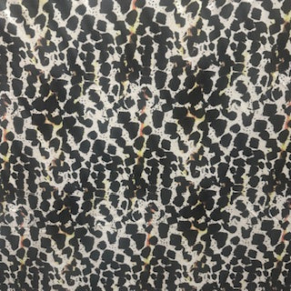 4 way Stretch tricot fabric with black and yellow spots on a beige back ground | Spandex Palace